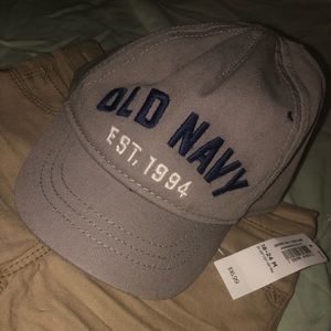 Brown slacks & Grey baseball hat